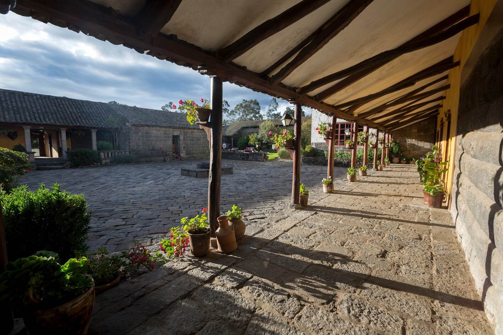 Sunlit stone courtyard at an Andean hacienda