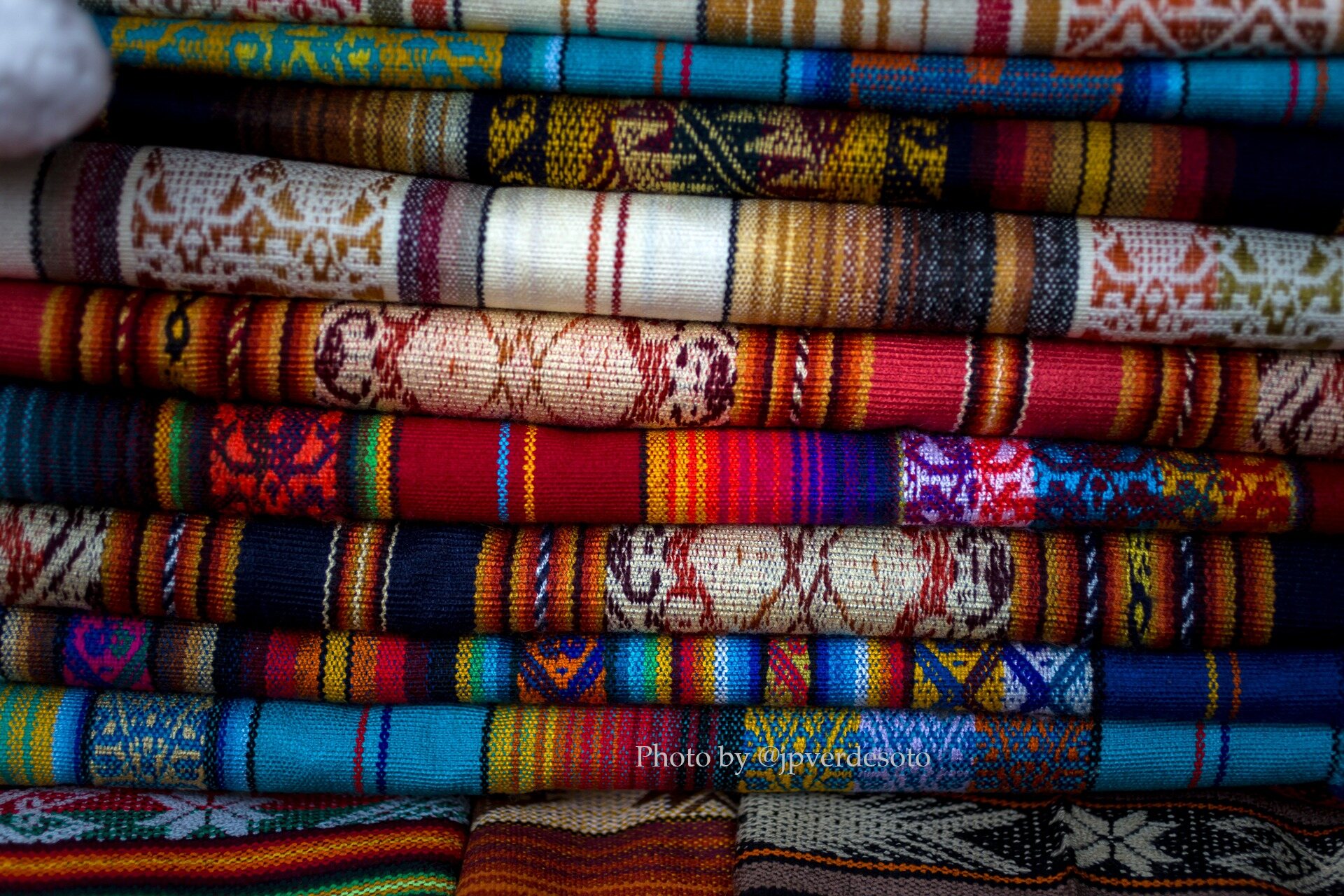 Colourful handwoven Andean textiles displaying traditional patterns