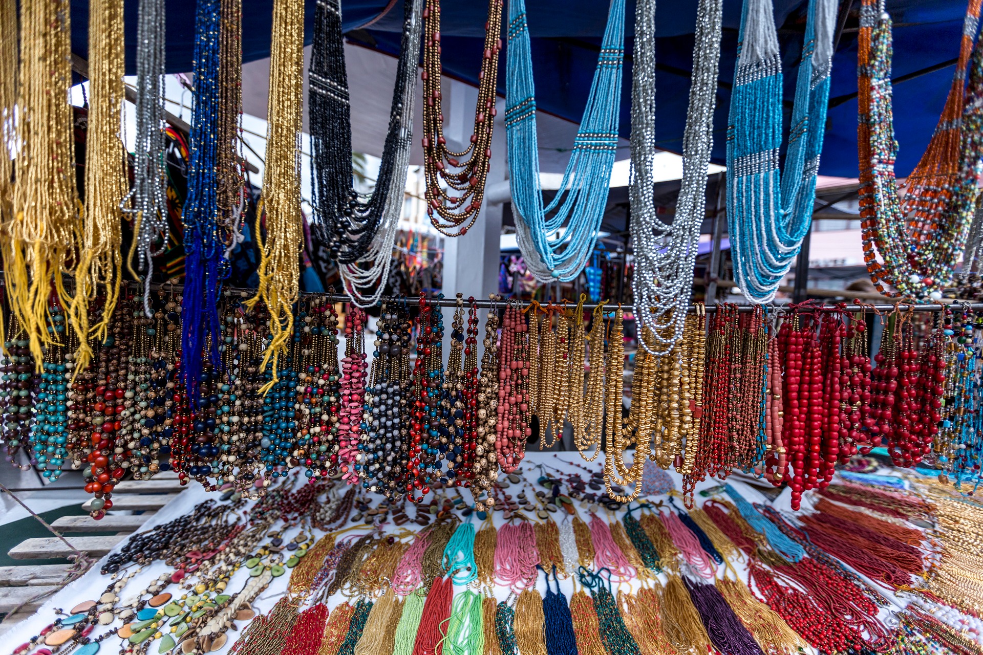 Colorful handmade necklaces and beadwork displayed at an artisan stall in Otavalo Ecuador