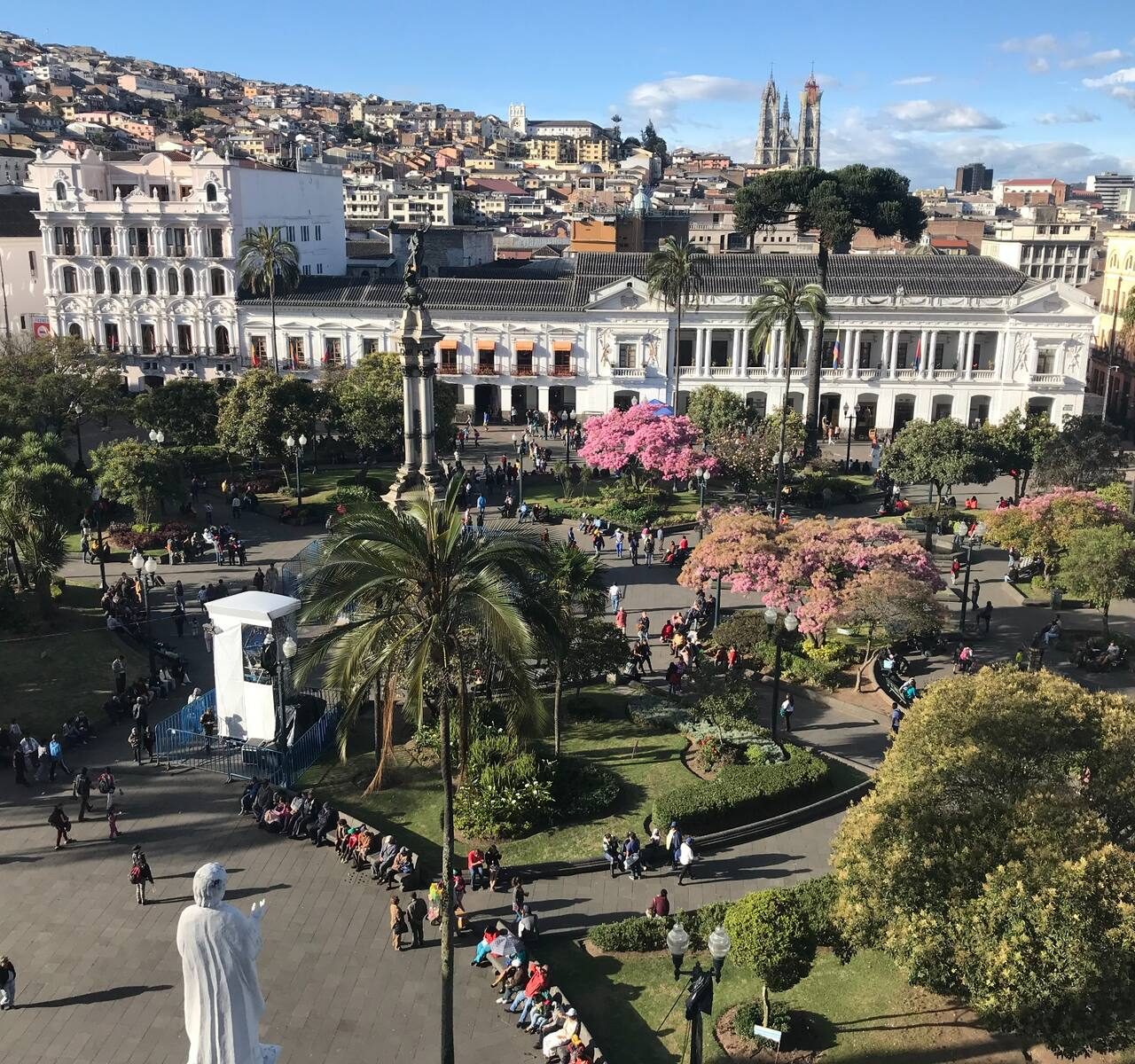 Panoramic view across the historic center of Quito with colonial architecture and hillside neighborhoods