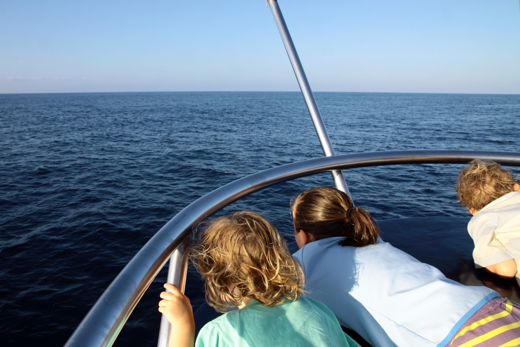 Guests watching the ocean from a Galapagos expedition boat