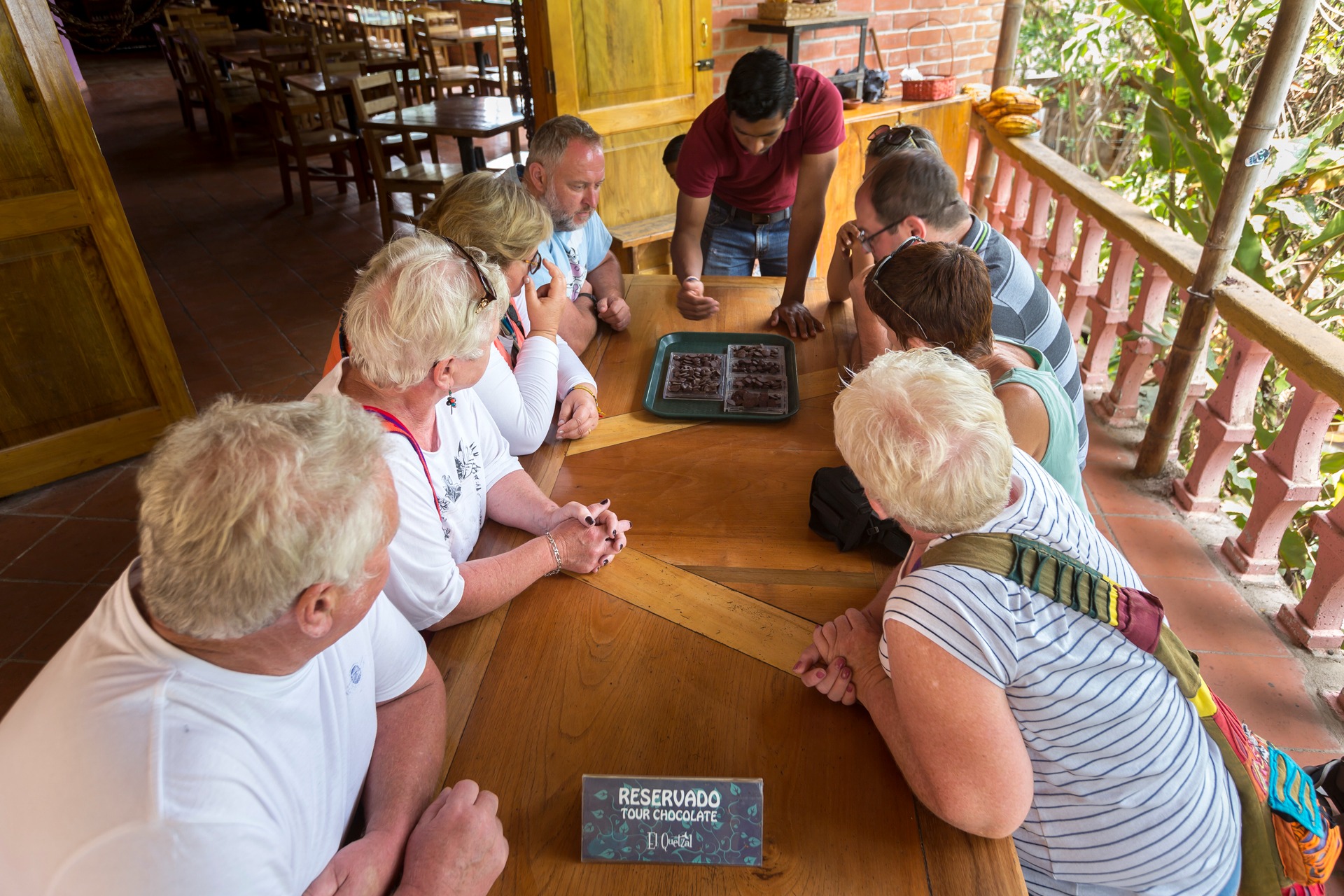 Travelers gathered around a table during a guided Ecuadorian cacao and chocolate tasting experience in Mindo