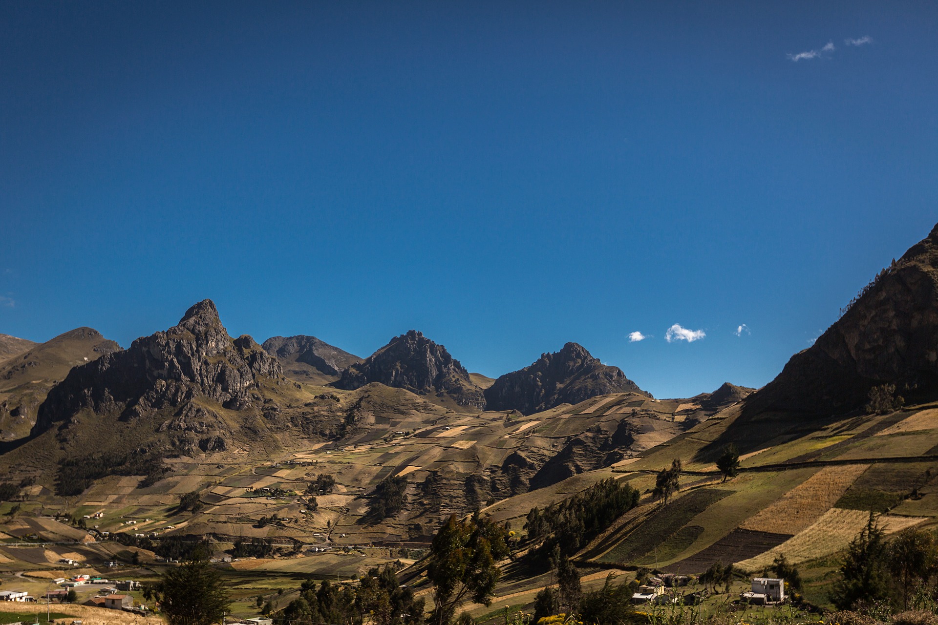 Patchwork farms and dramatic volcanic mountains in the Ecuadorian highlands near Quilotoa