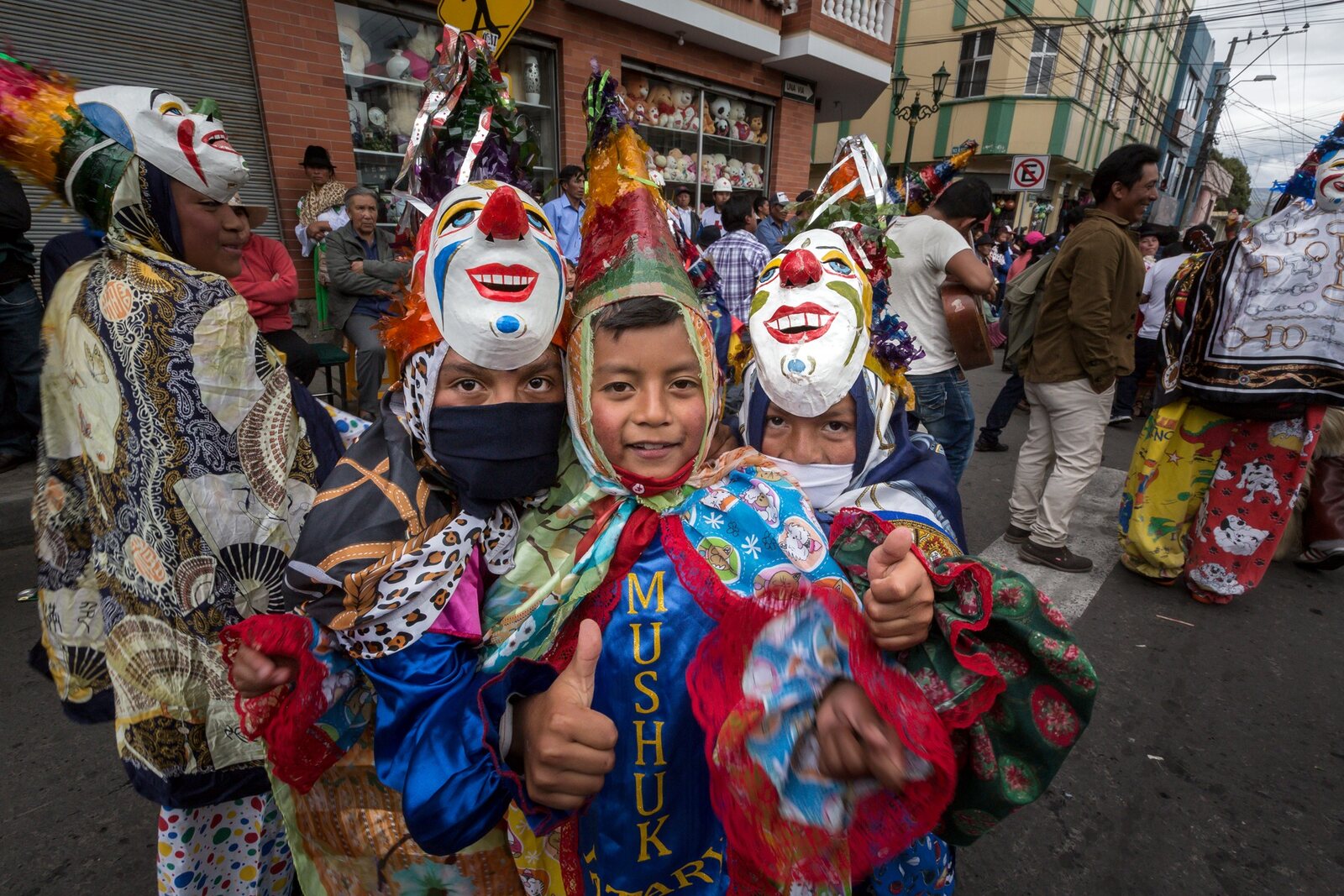 Children in colorful traditional costumes during a cultural celebration in an Ecuadorian Andean town
