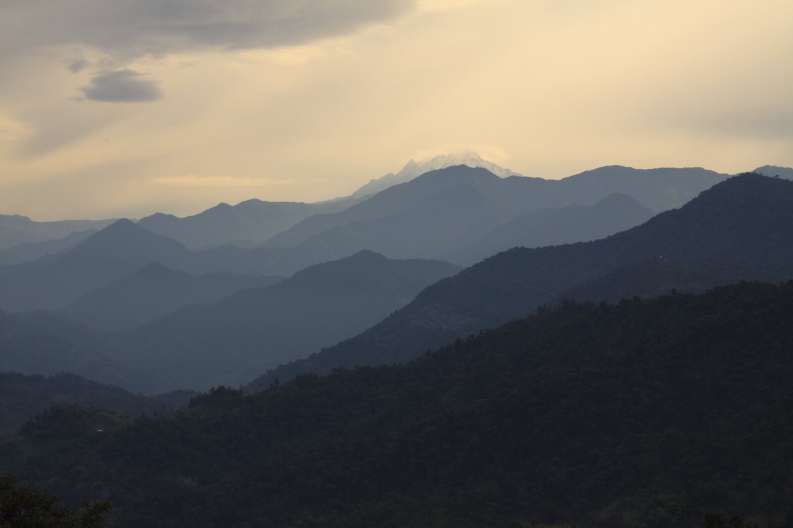 Layered Andean mountain ranges beneath warm evening light along Ecuador’s Avenue of the Volcanoes